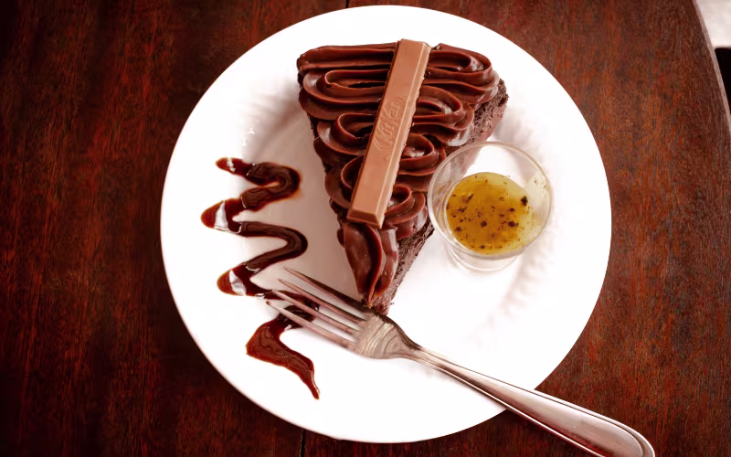 Top View of a Slice of Chocolate Cake with a Kit Kat Bar